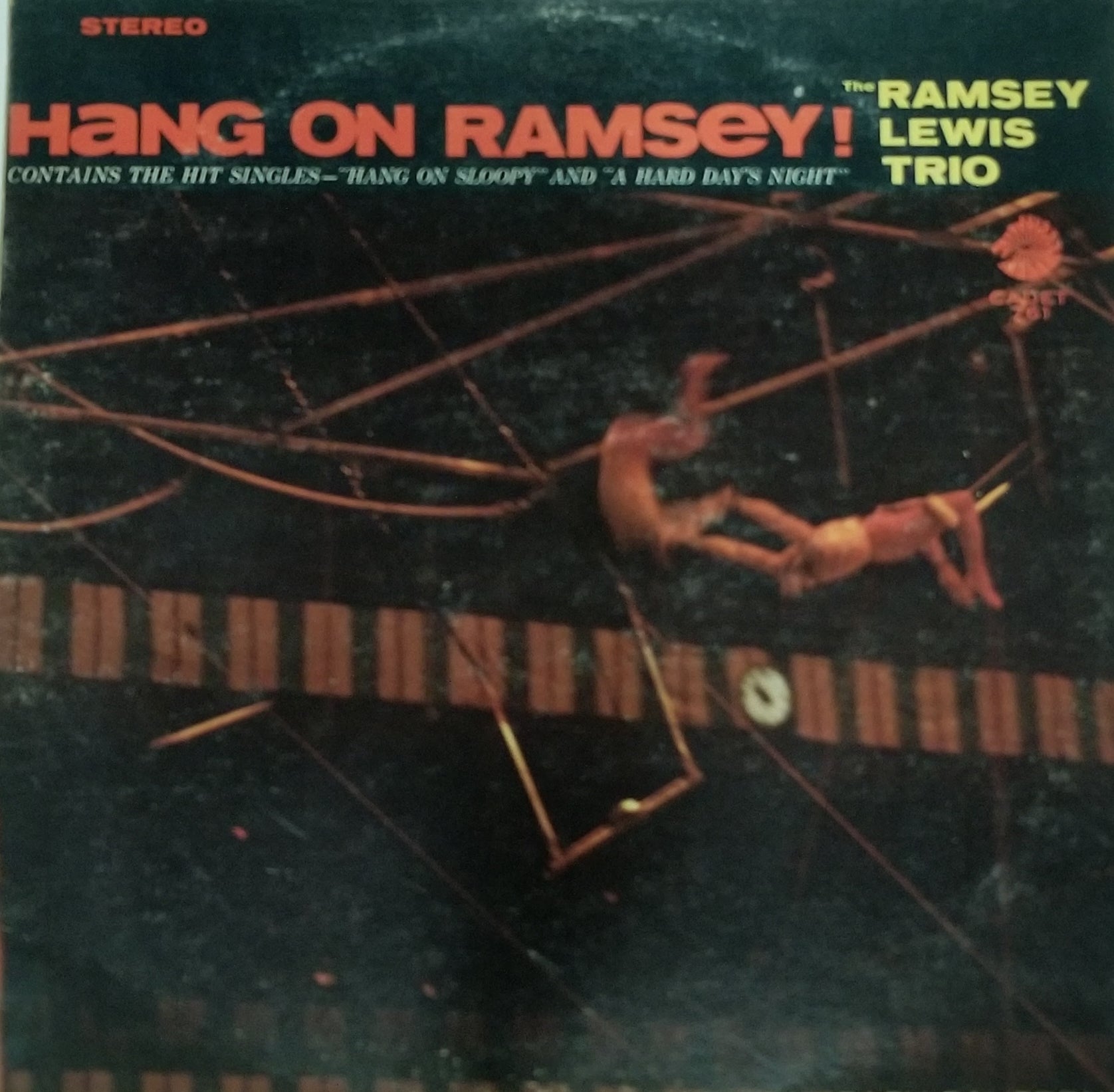 Album cover of 'Hang On Ramsey!' by The Ramsey Lewis Trio with a person on a trapeze.