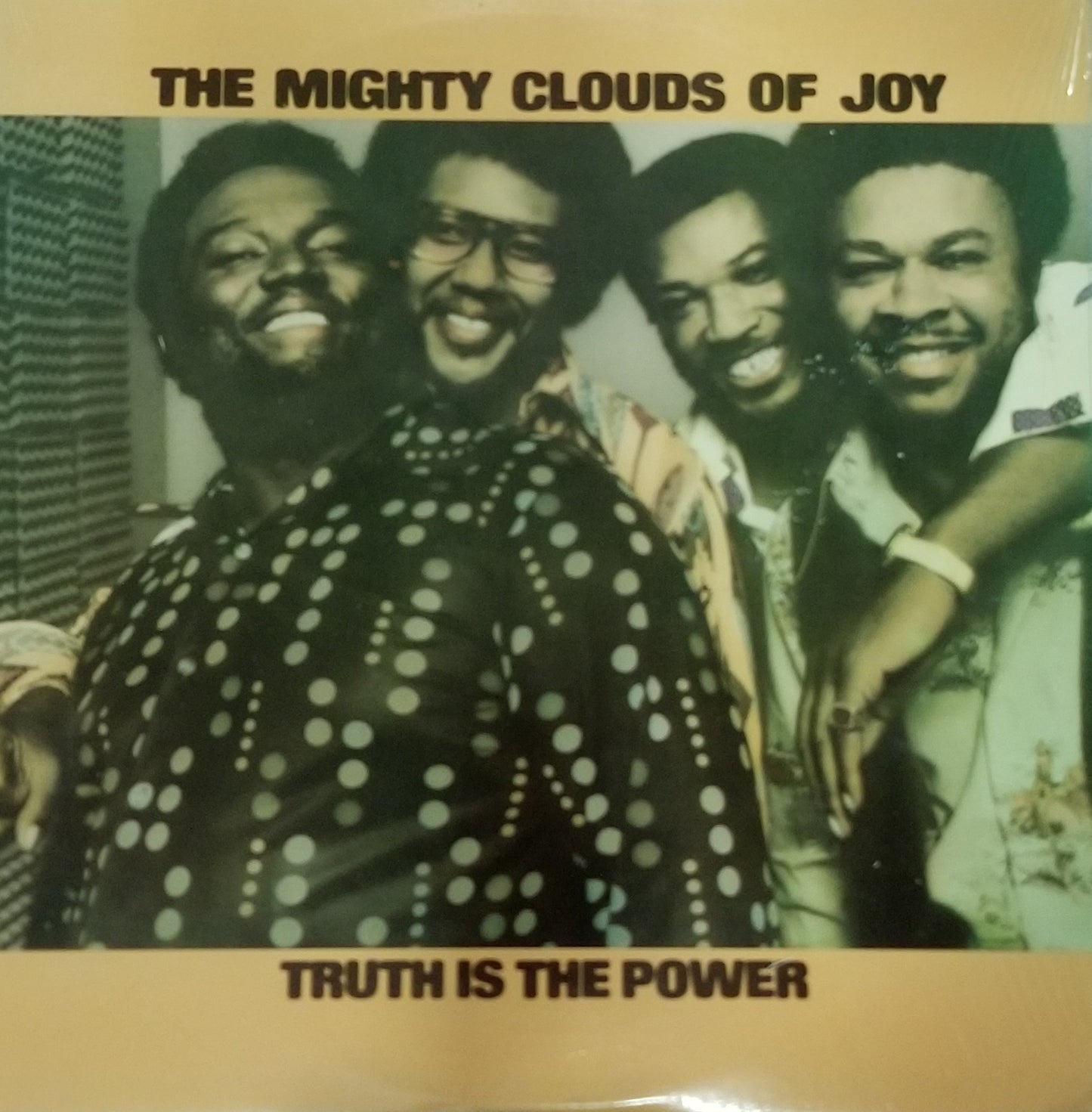 Album cover of 'The Mighty Clouds of Joy' with a group photo and text 'Truth is the Power'.