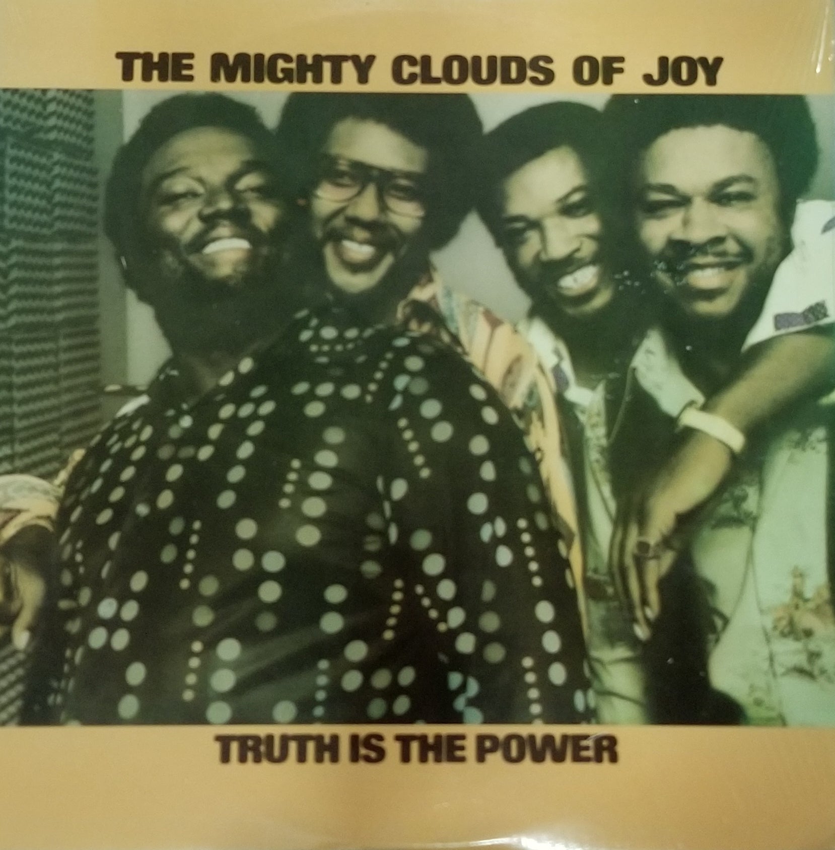 Album cover of 'The Mighty Clouds of Joy' with a group photo and text 'Truth is the Power'.